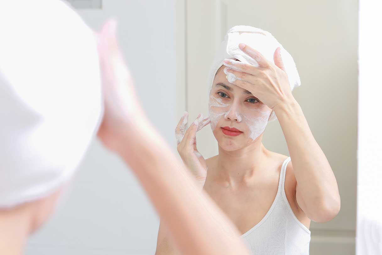 Woman applying skincare mask to her face