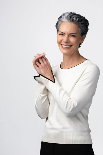 Smiling woman in white shirt