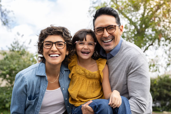 Man, woman, and little girl, all with glasses