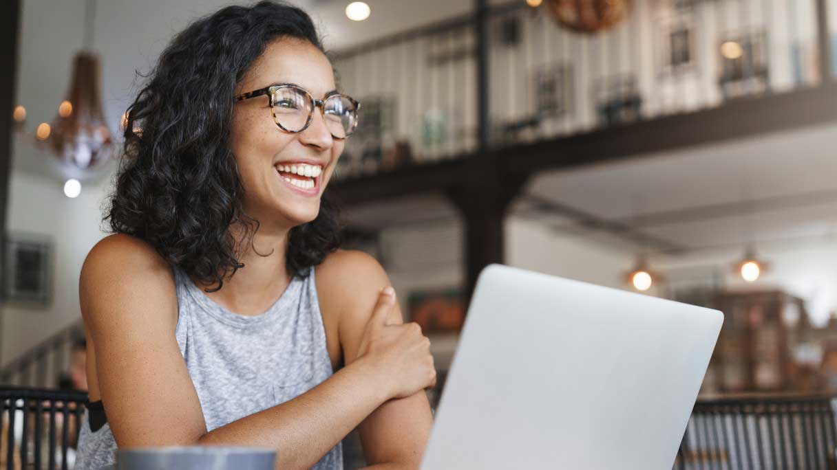 Woman at laptop smiling