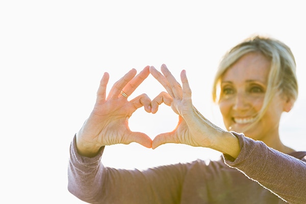 Woman making a heart shape with her hands