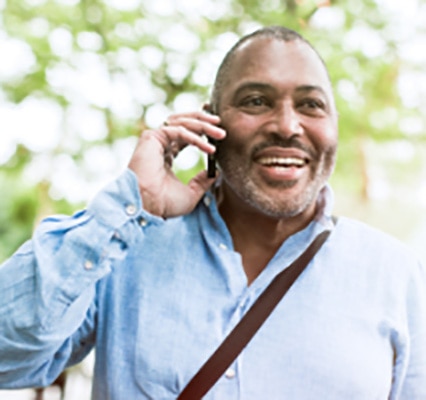 Man smiling while talking on cellphone