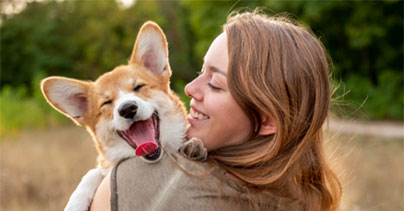 Woman hugging happy dog