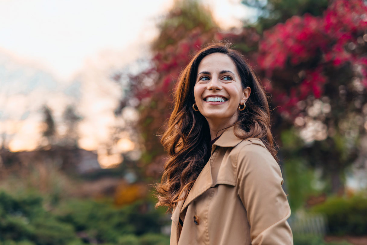 Smiling woman standing outside
