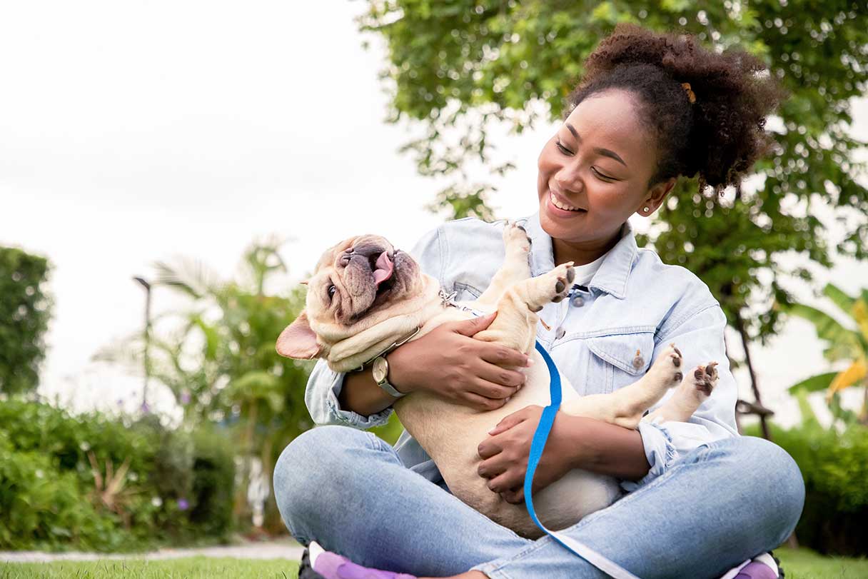 Smiling woman holding dog