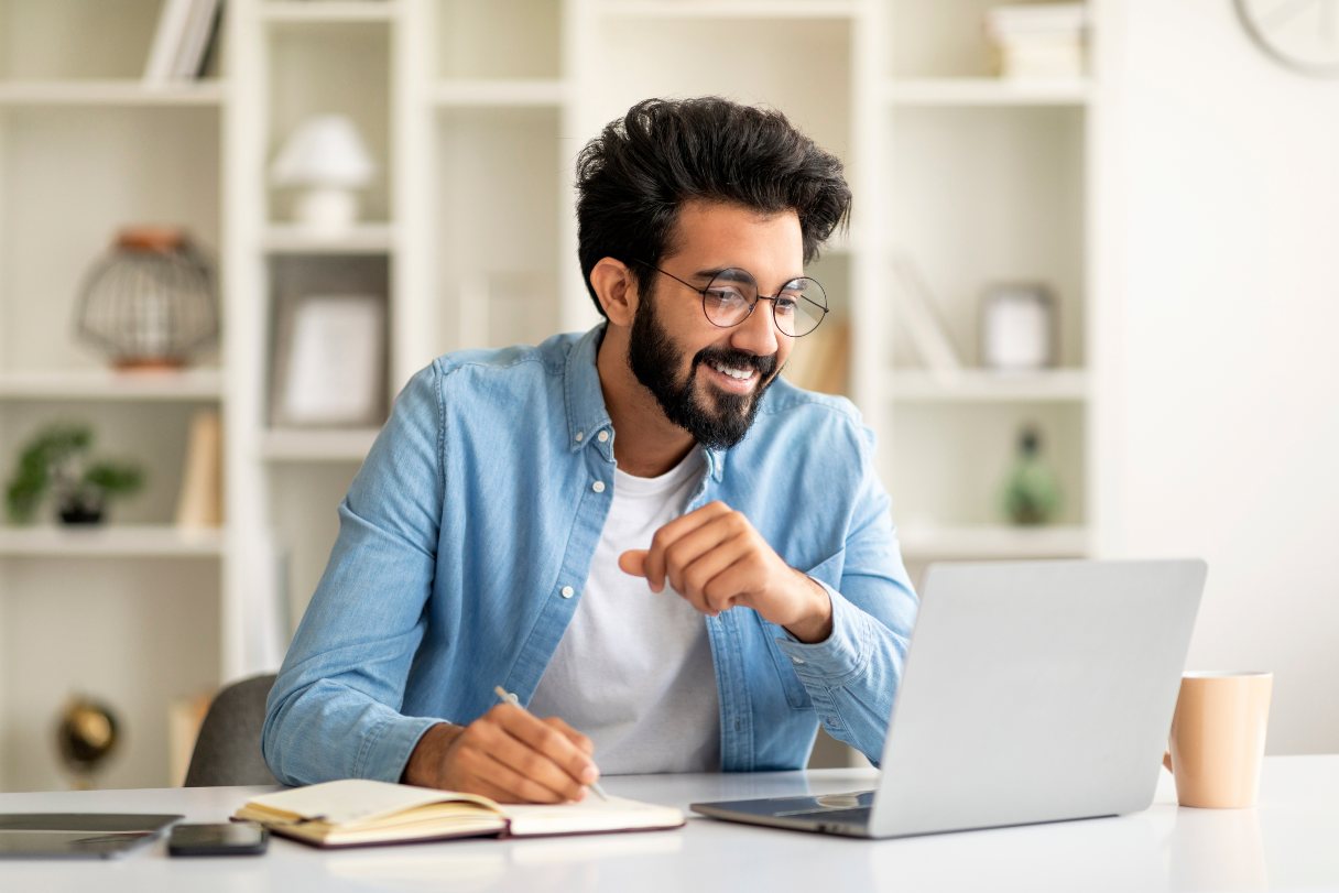Man in glasses working on laptop