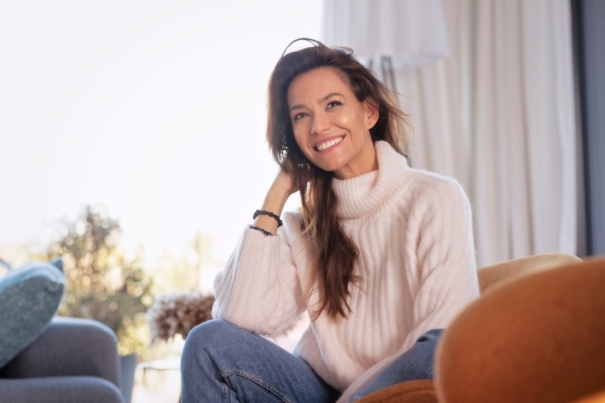 Smiling woman sitting in arm chair
