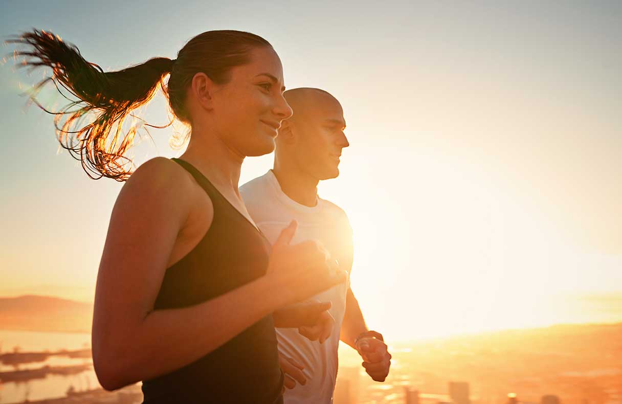 Man and woman running outside together