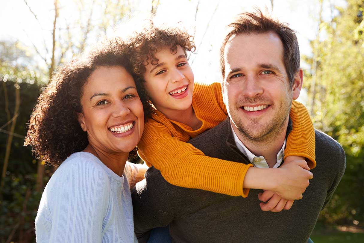 Couple with a young boy, smiling