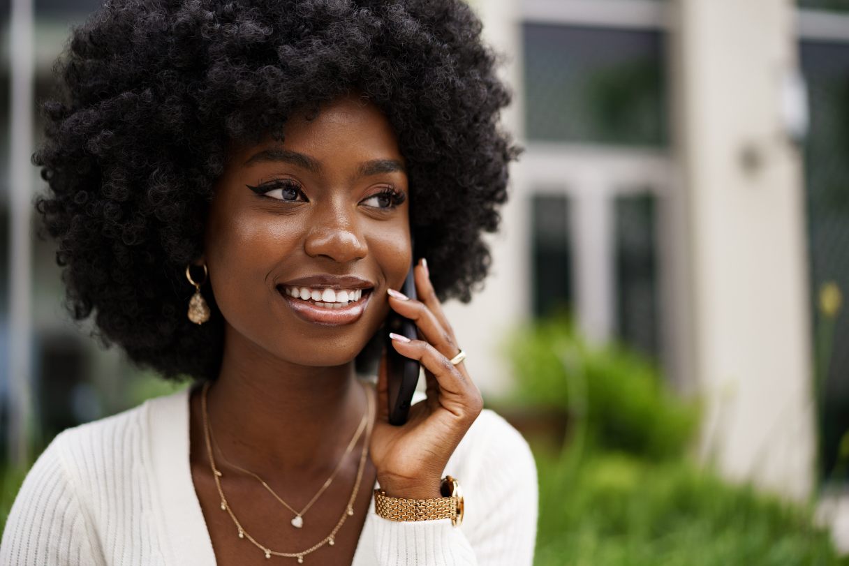 Smiling woman speaking on mobile phone