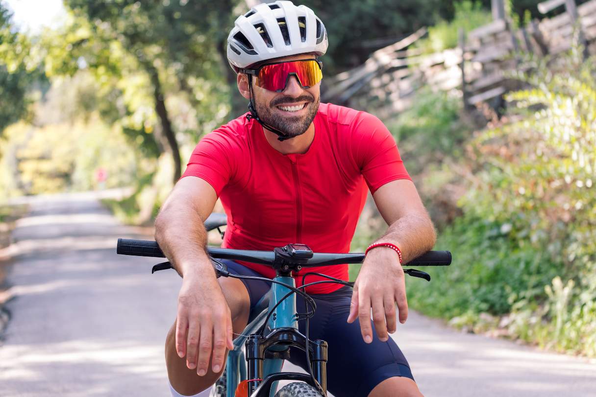 Man in sunglasses riding bike outside