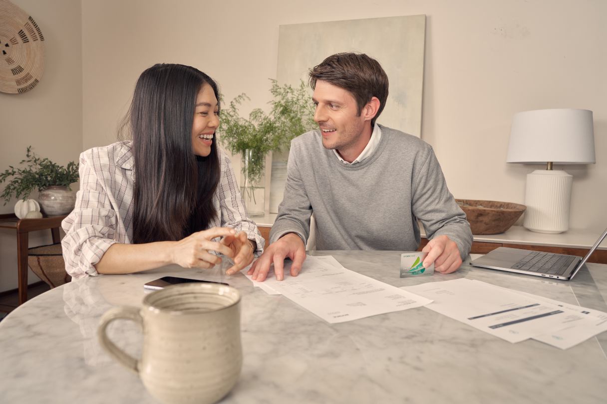 Couple with CareCredit credit card, looking over financial documents