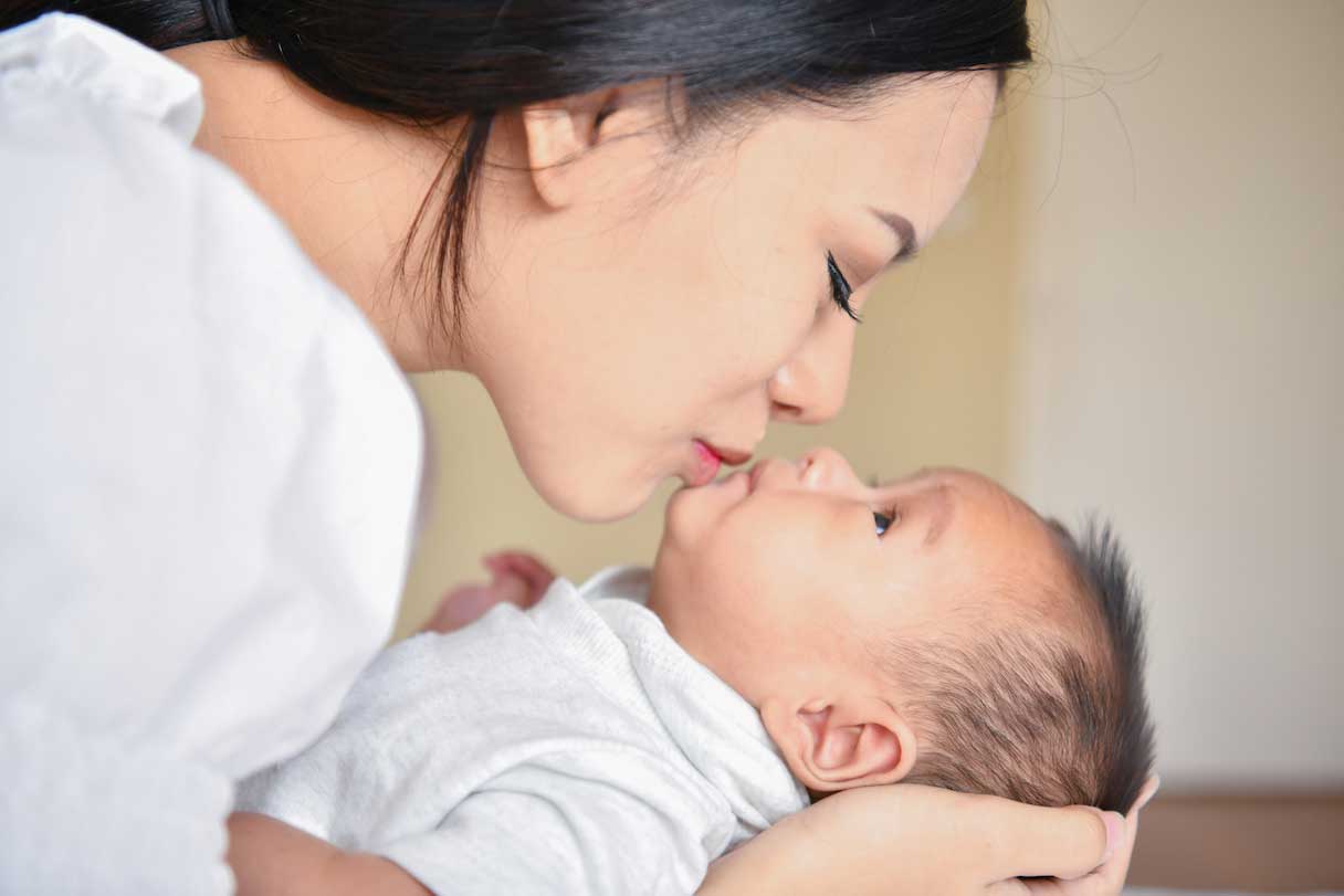 Woman kissing baby