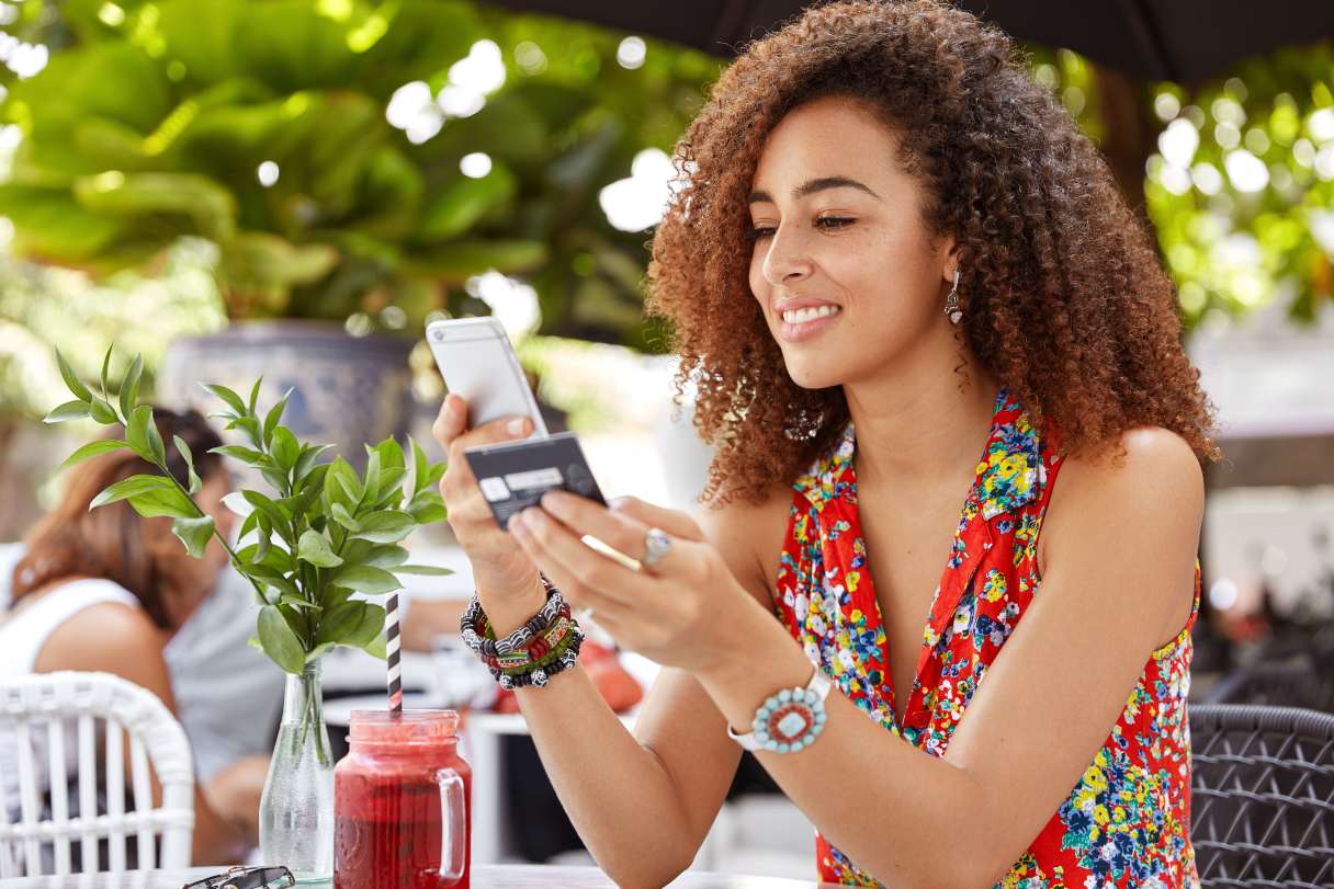 Woman holding credit card and mobile phone