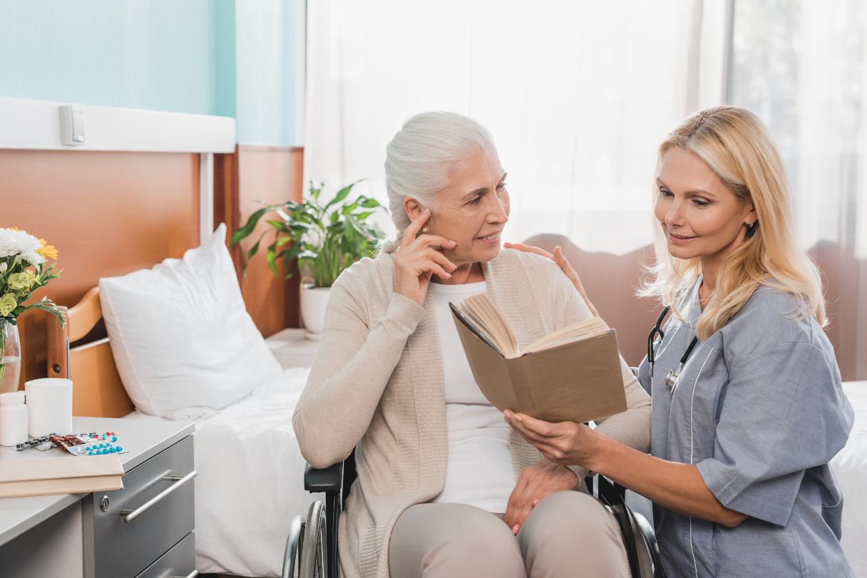 Woman reading to a senior woman