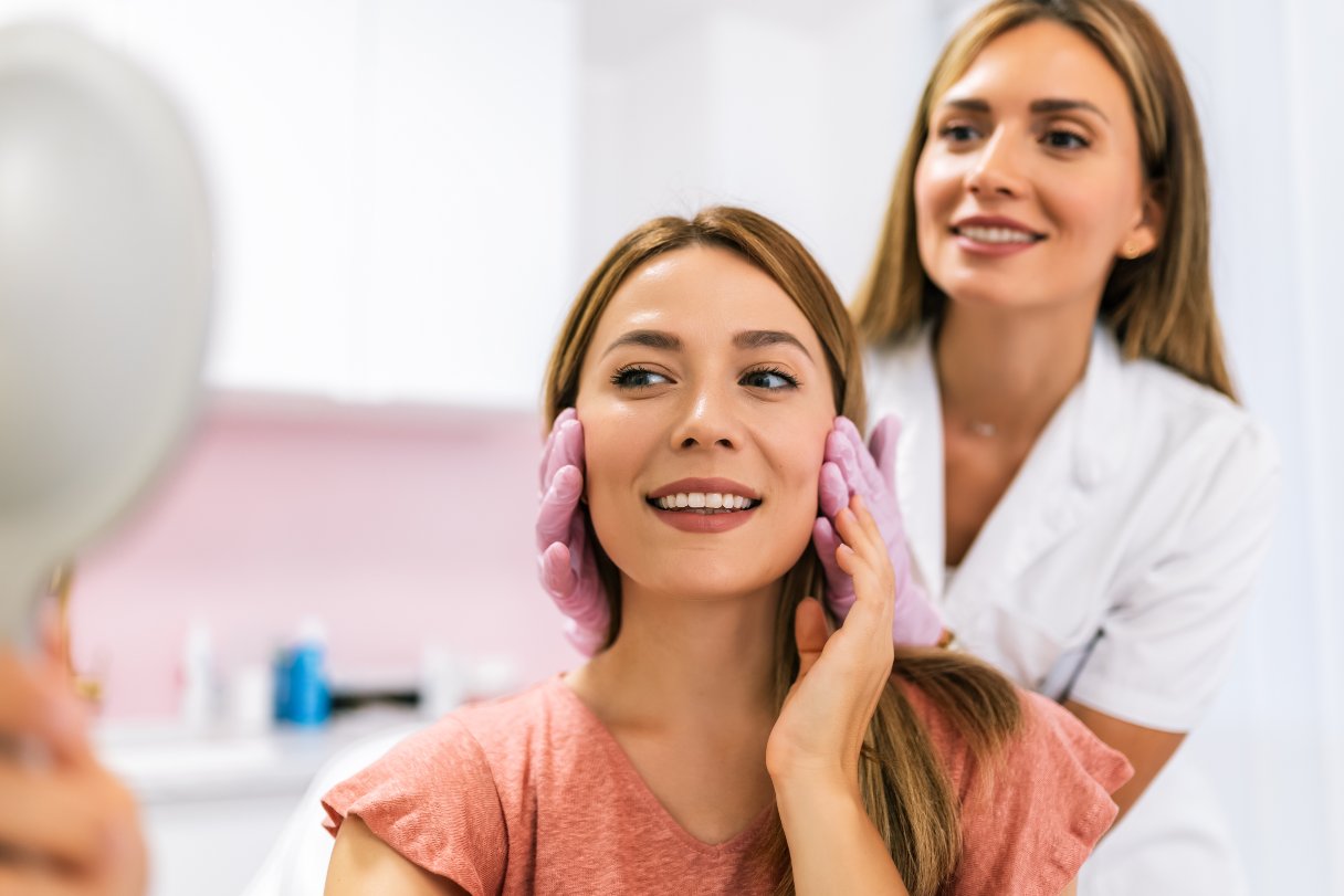 Dermatologist assessing a woman's face