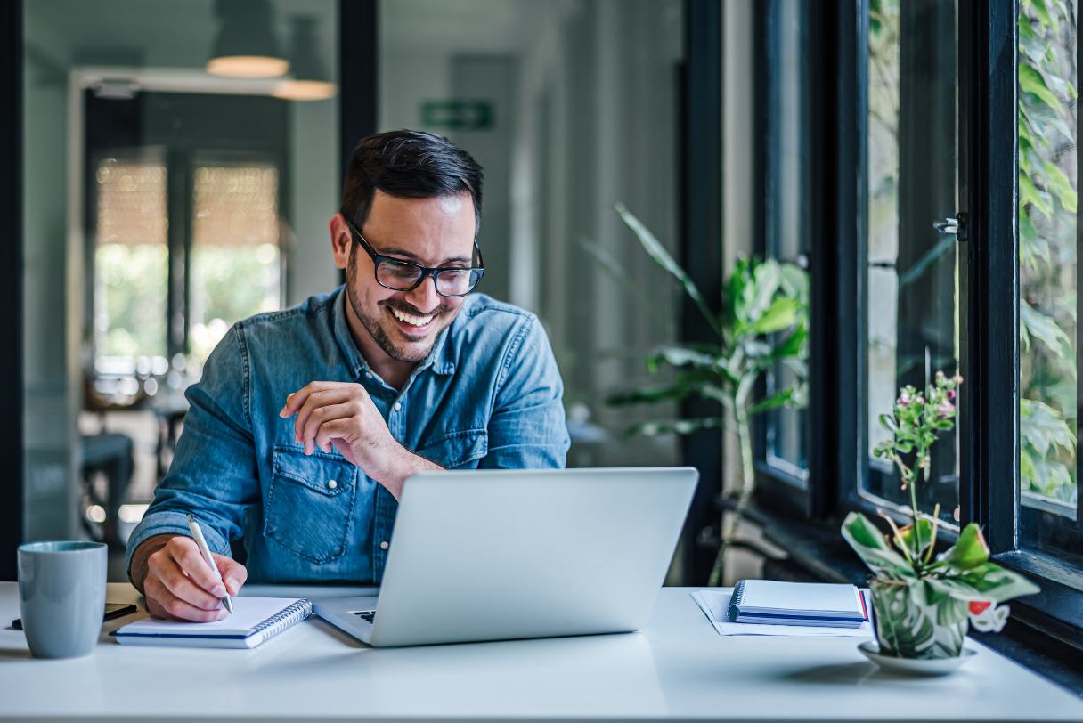 Man in glasses working on a laptop