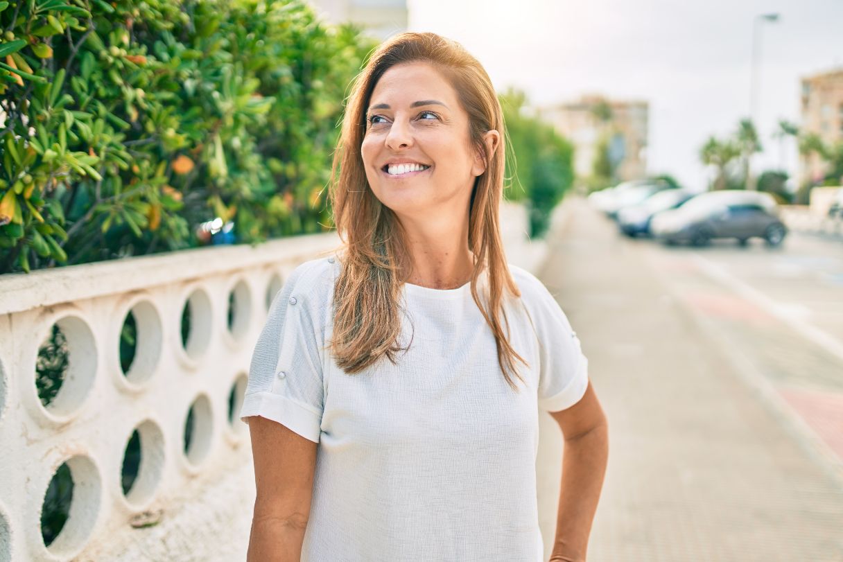 Smiling woman walking outside