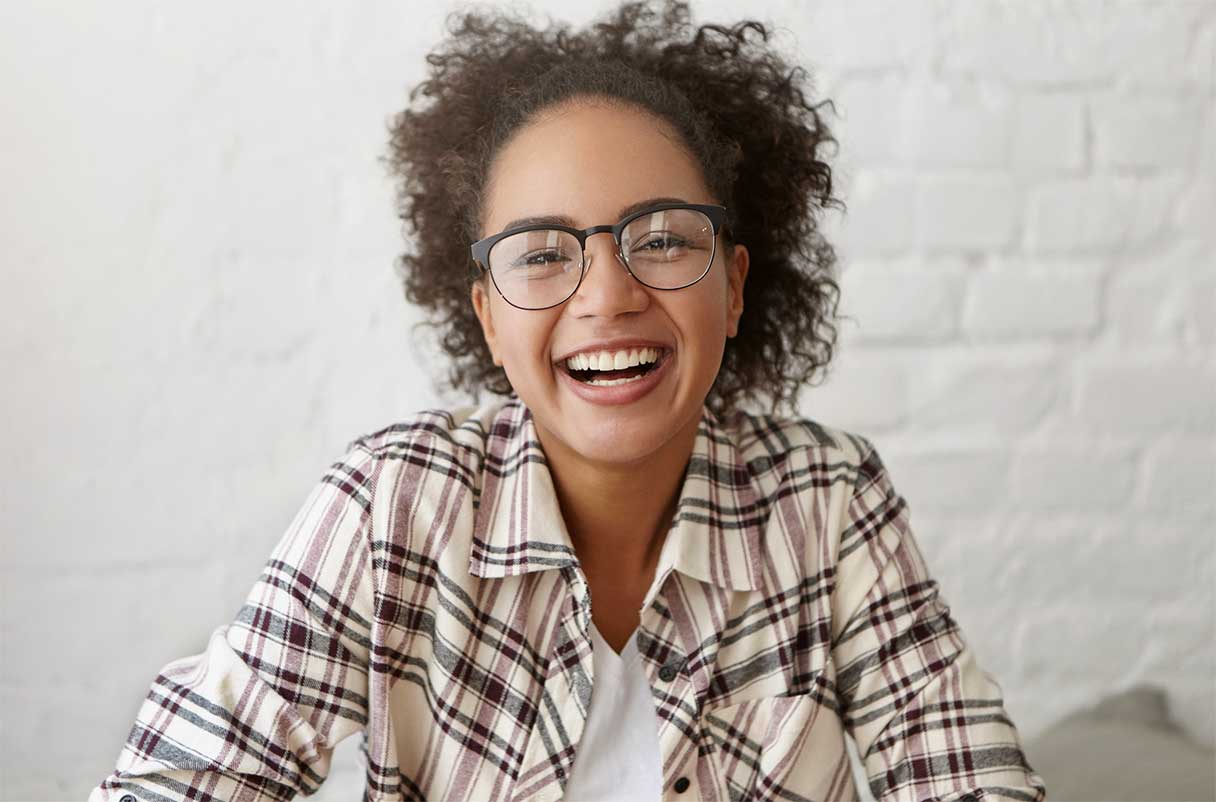 Young woman wearing eye glasses and smiling
