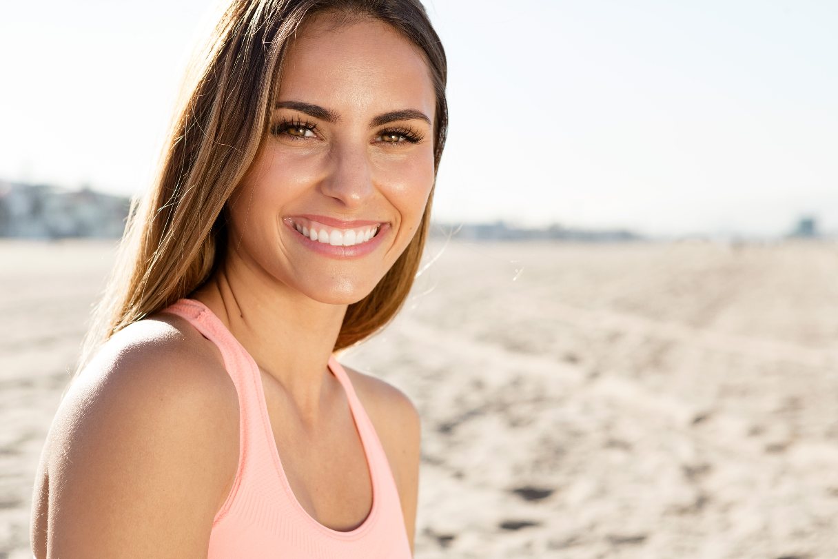 Smiling woman with long eyelashes on a beach
