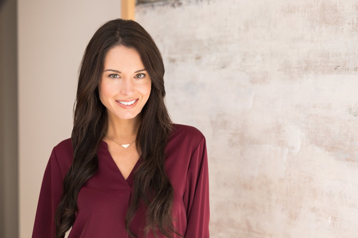 Woman in a red top, smiling
