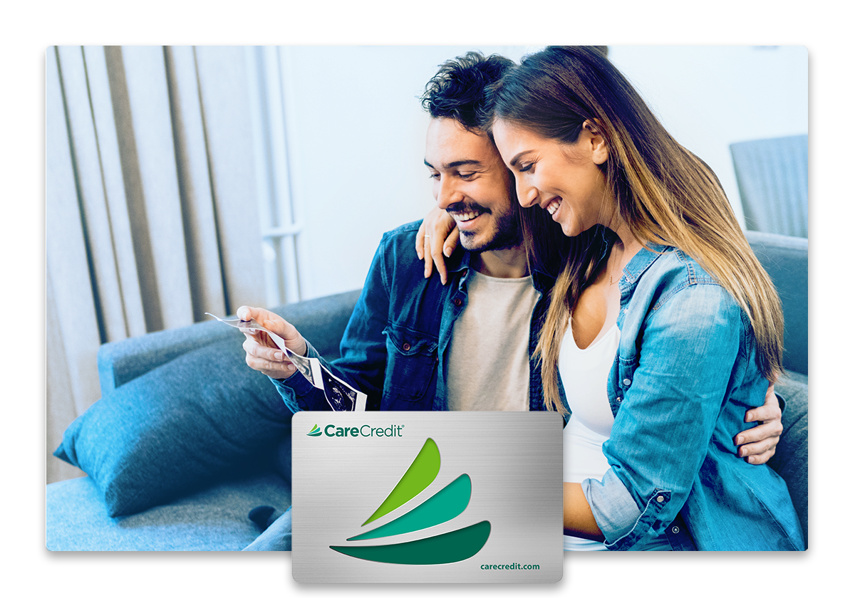 Couple looking at sonogram and CareCredit credit card