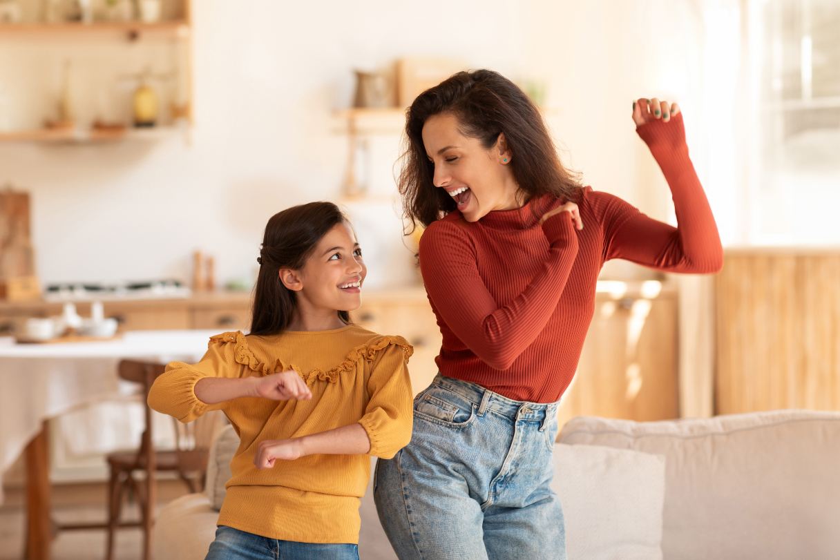 Woman bumping hips with her daughter