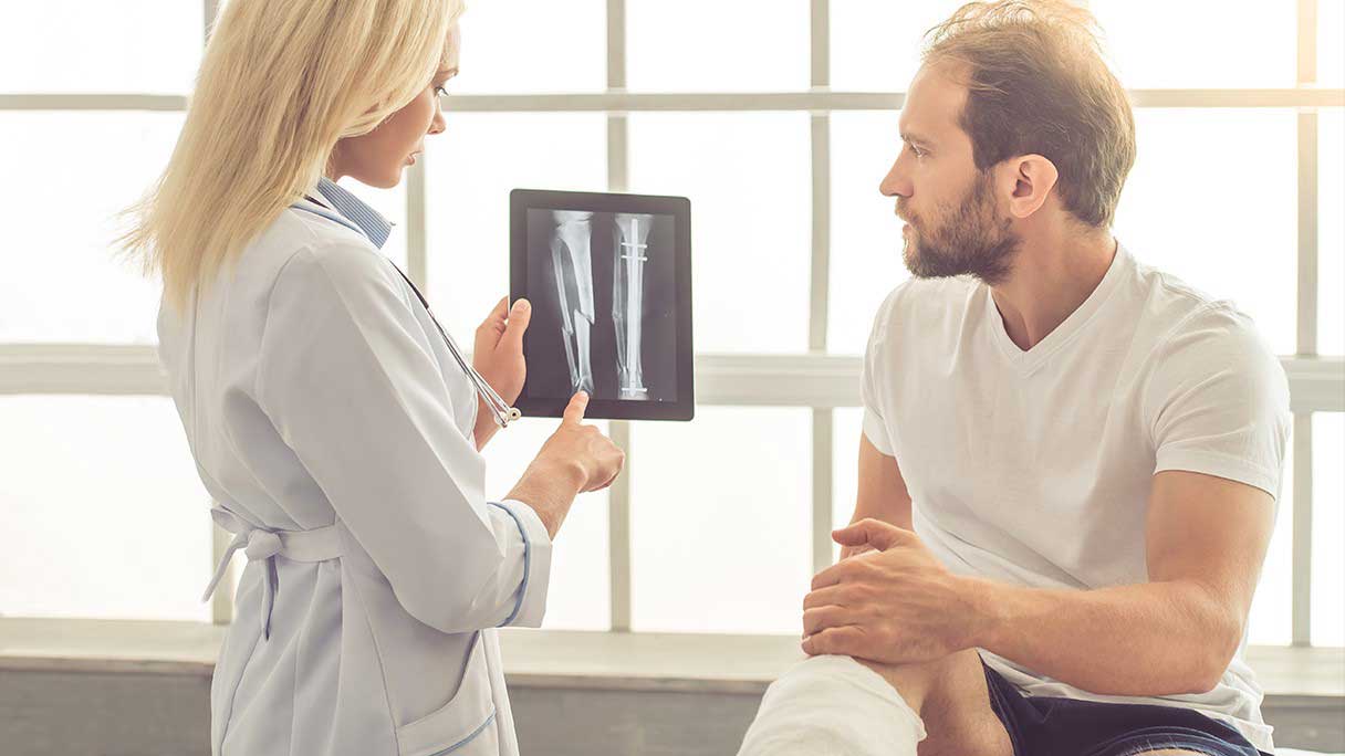 Doctor showing a man an x-ray