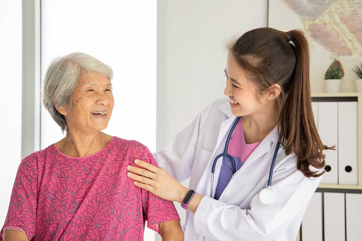 Doctor and senior woman smiling