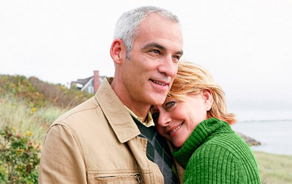 Man and woman standing near the ocean