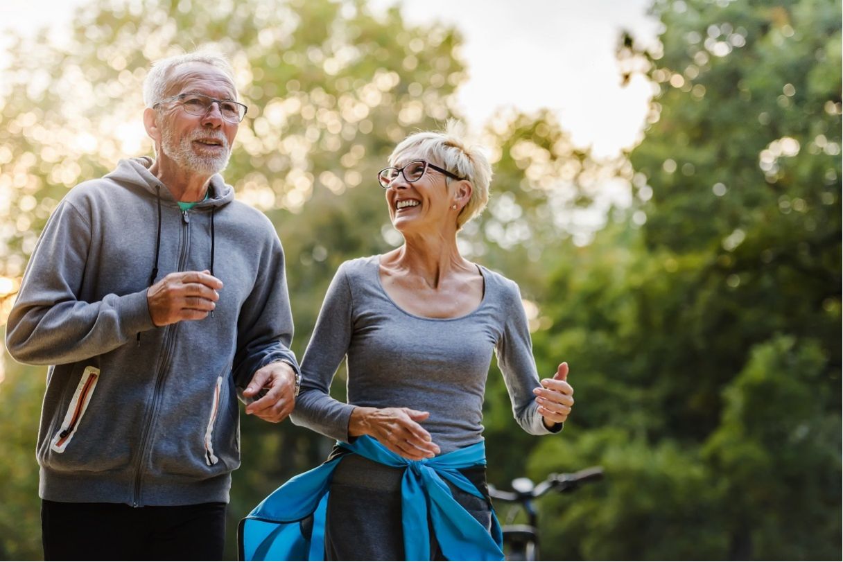 Senior man and woman, running together