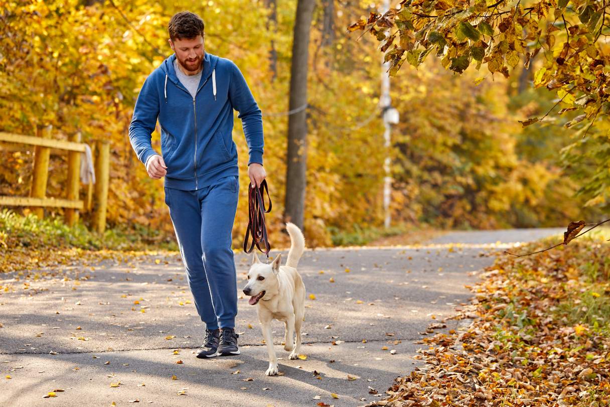Man running with dog outside