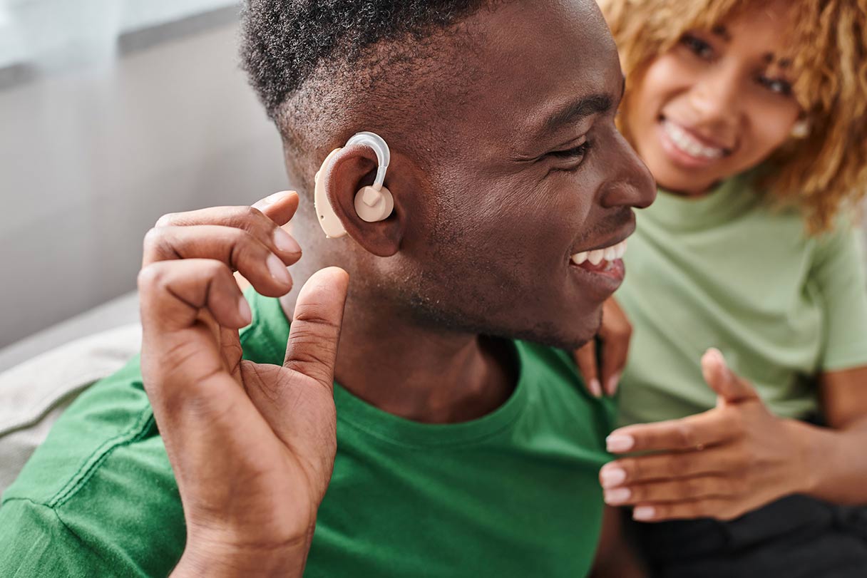 Man being fitted with a hearing aid