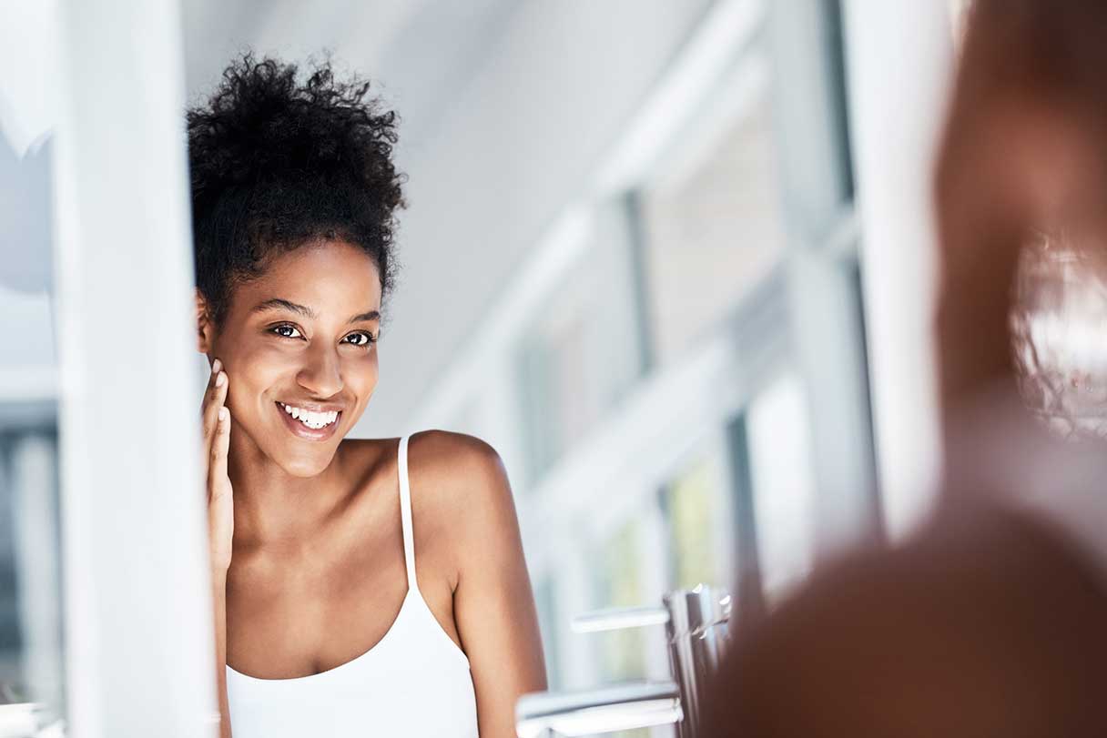 Woman smiling at her reflection