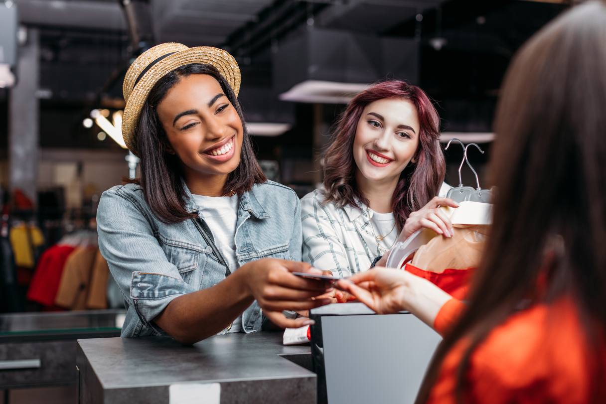 Woman at retail register, paying with credit card