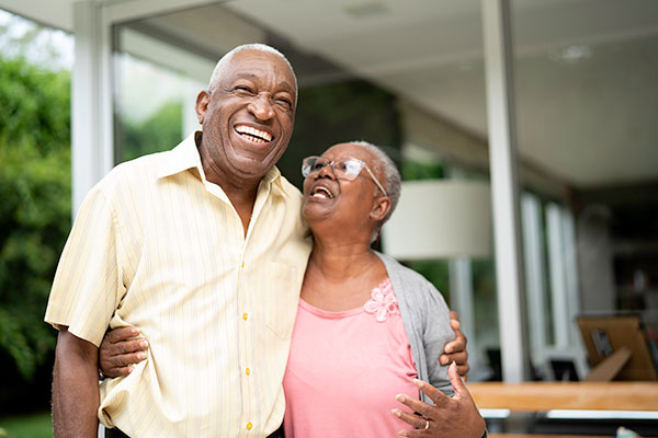 Senior couple, standing outside and laughing