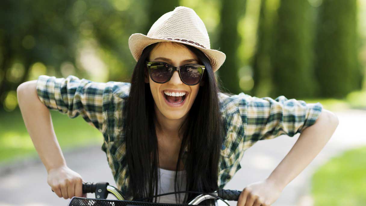 Smiling woman riding a bike