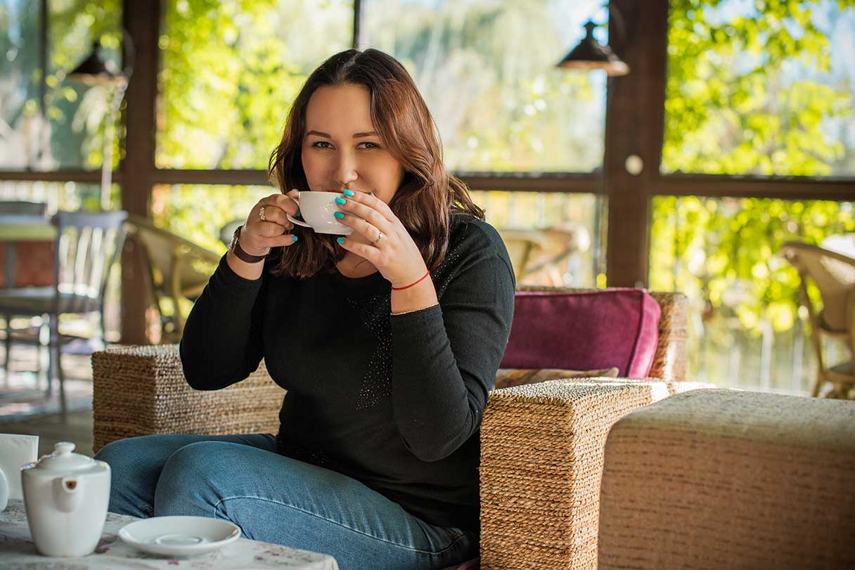 Woman drinking out of a coffee mug