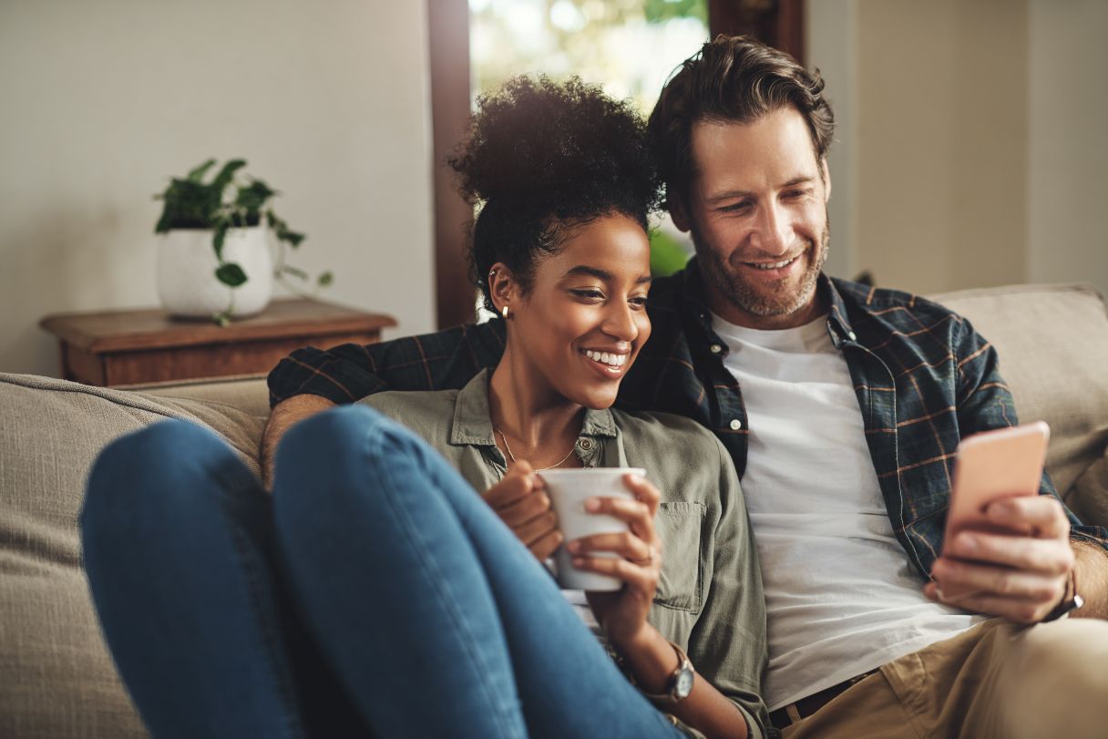 Man and woman sitting on couch together