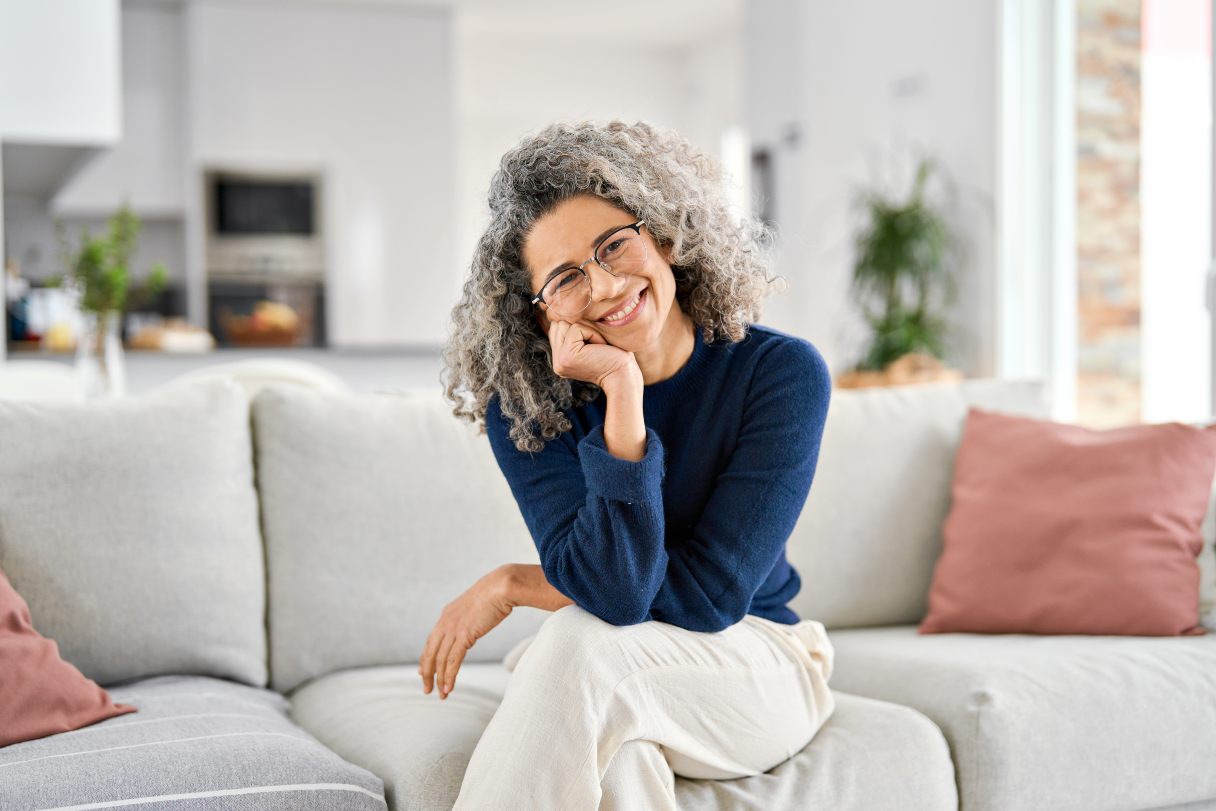 Smiling woman sitting on sofa