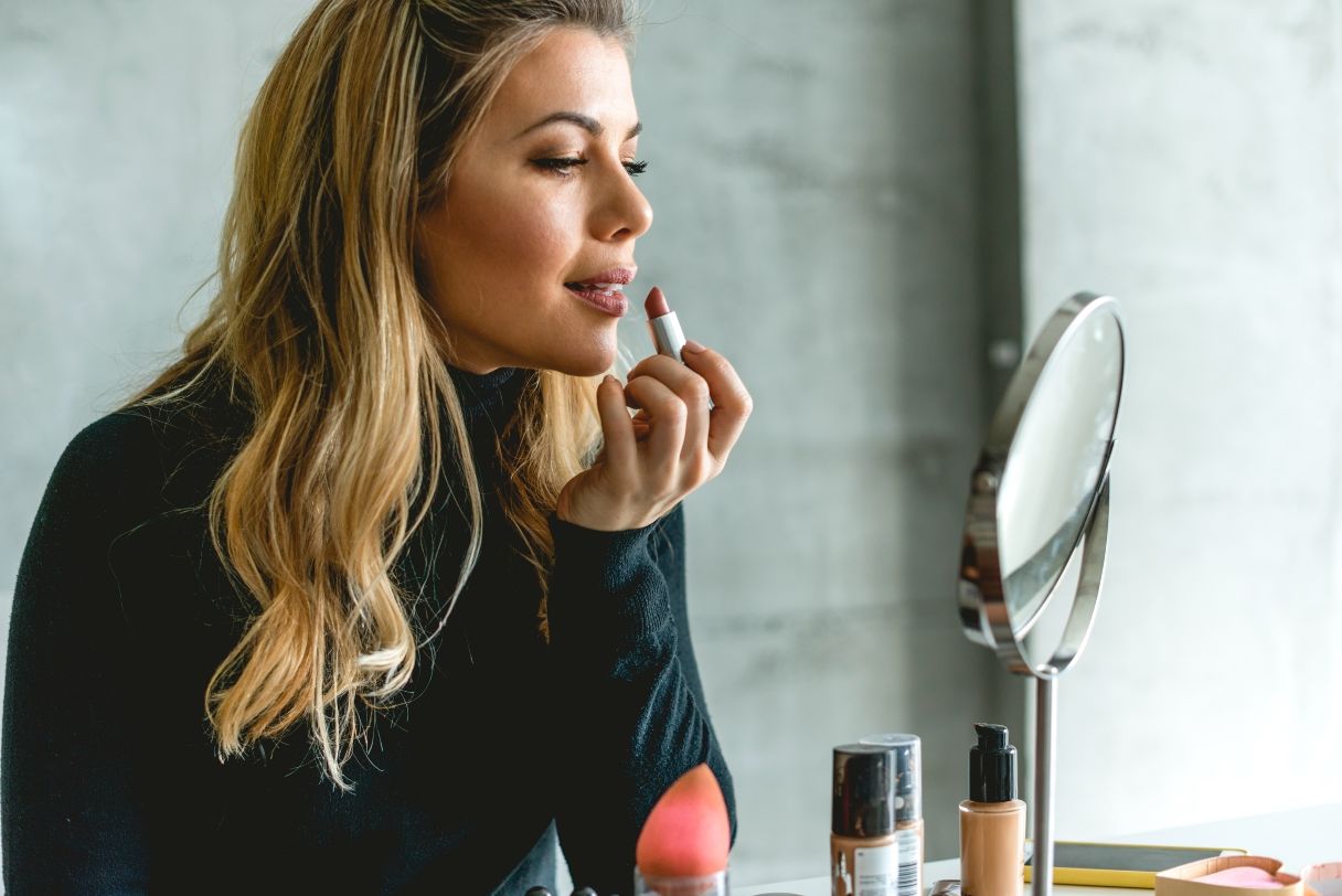 Woman applying lipstick