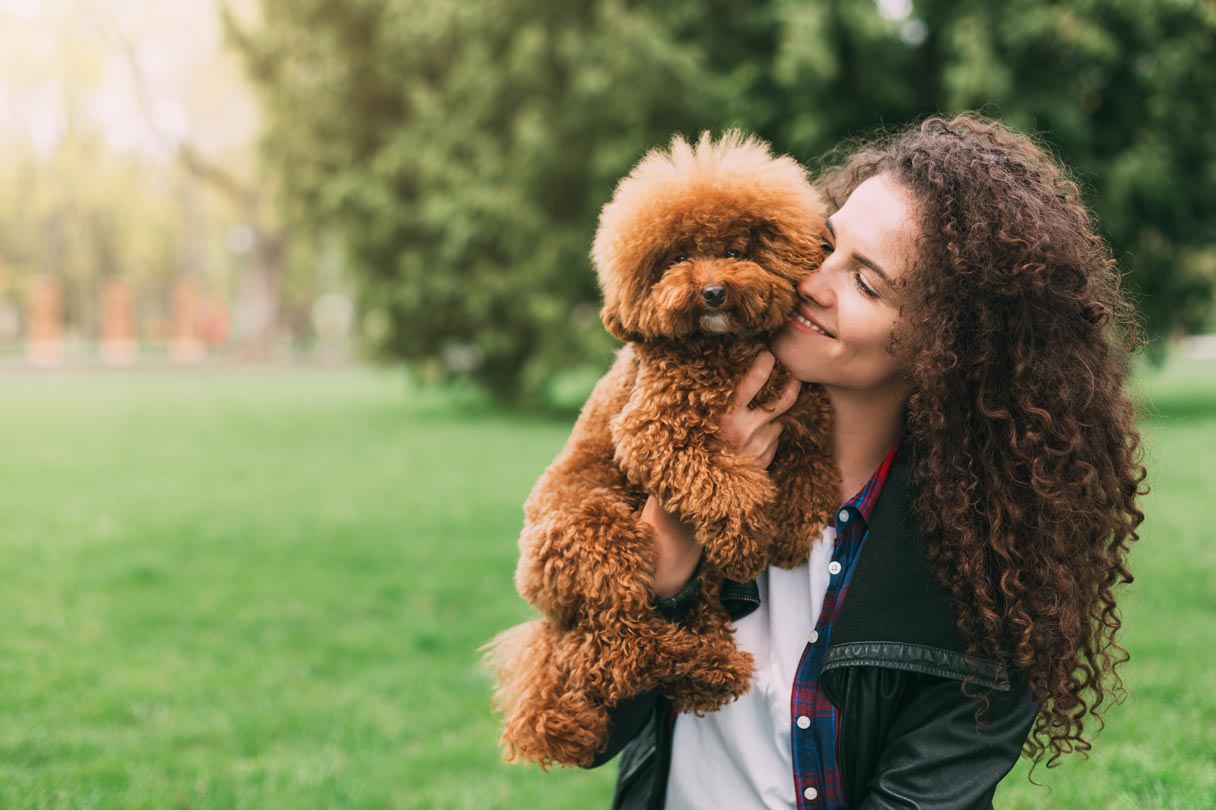 Woman holding brown dog