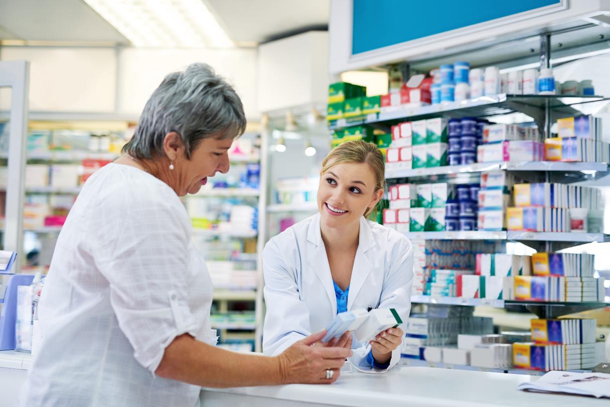 Pharmacist speaking with woman
