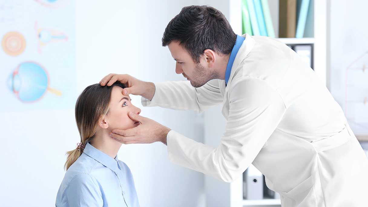 Man inspecting a woman's eye