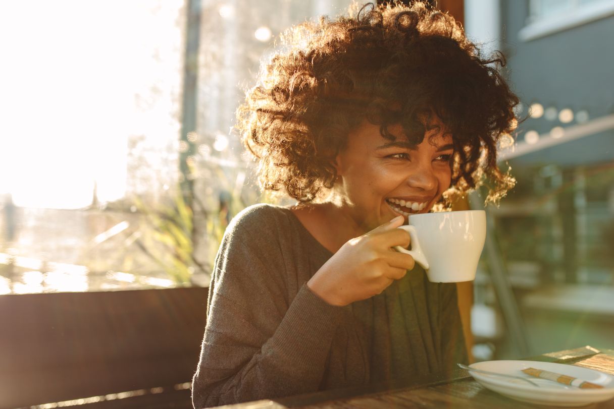 Smiling woman drinking coffee