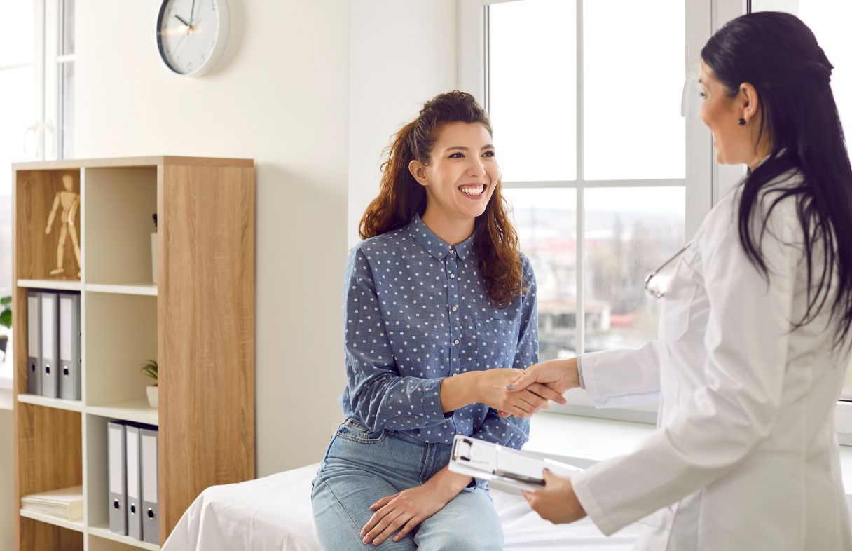 Woman shaking hand with doctor