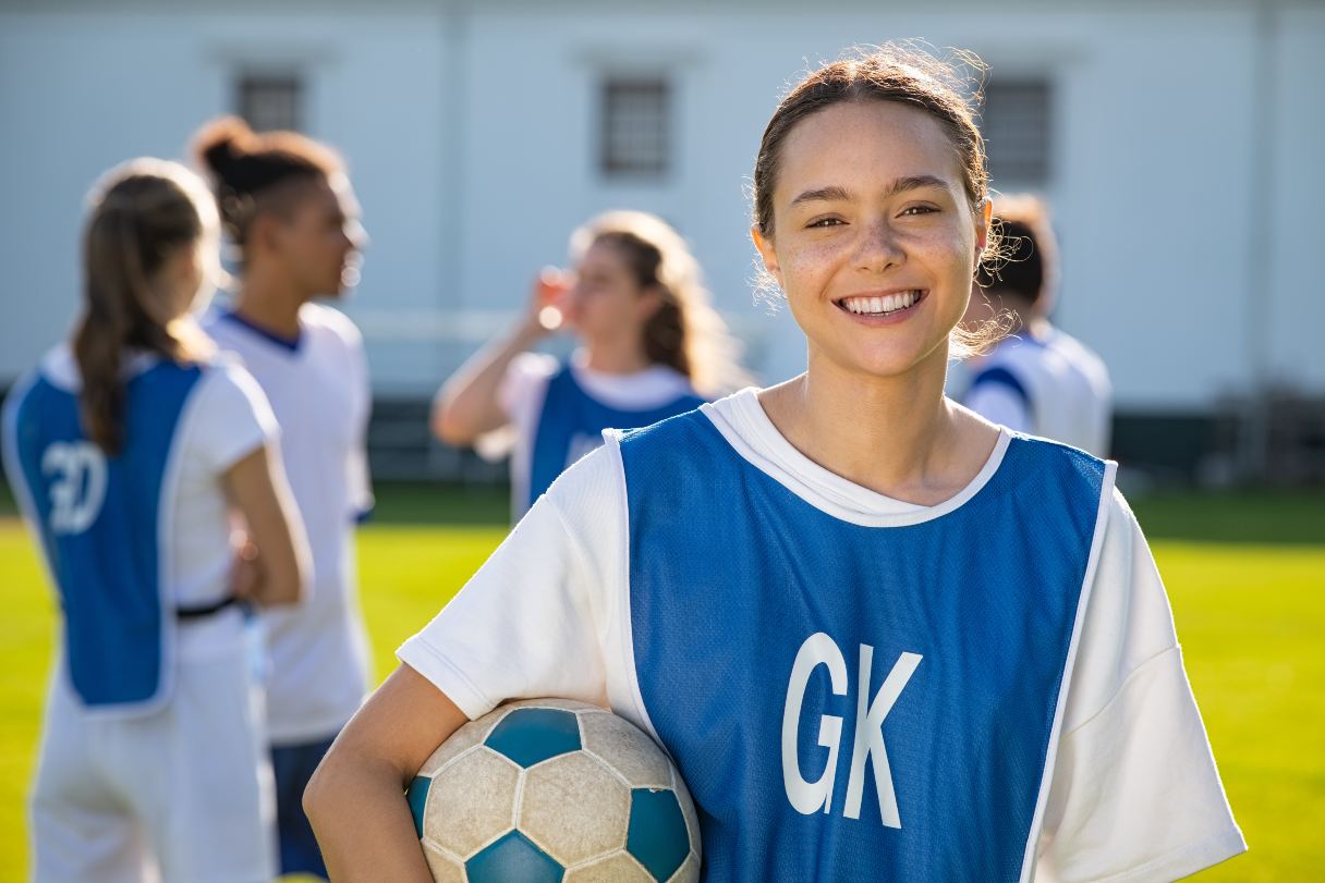 Teenage girl holding soccer ball