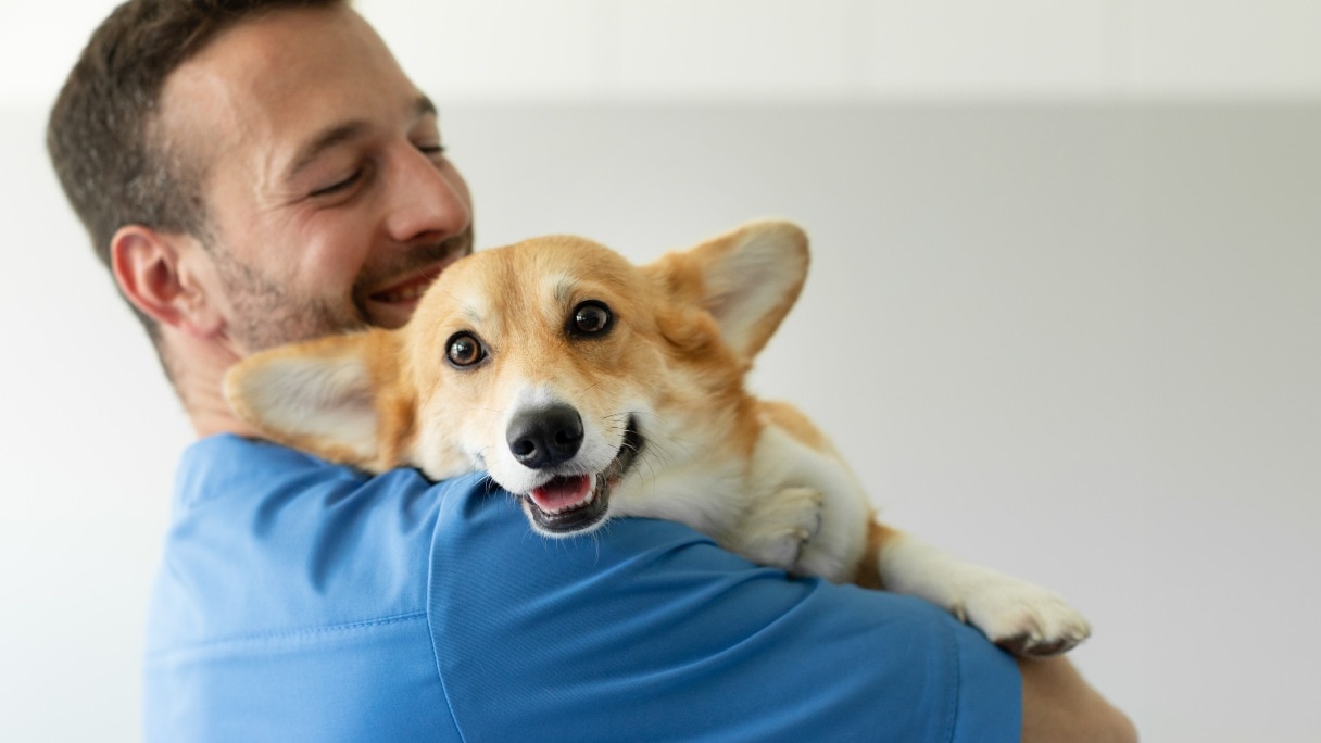 Man holding a corgi