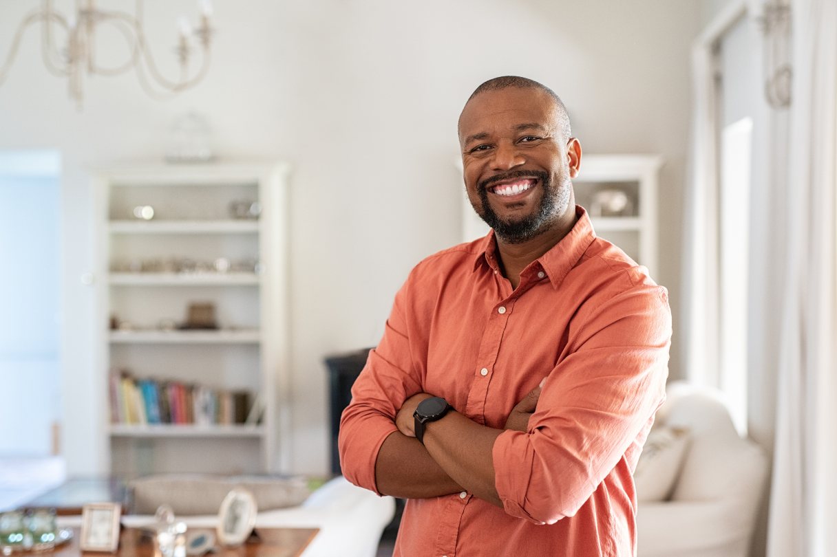 Smiling man standing in living room
