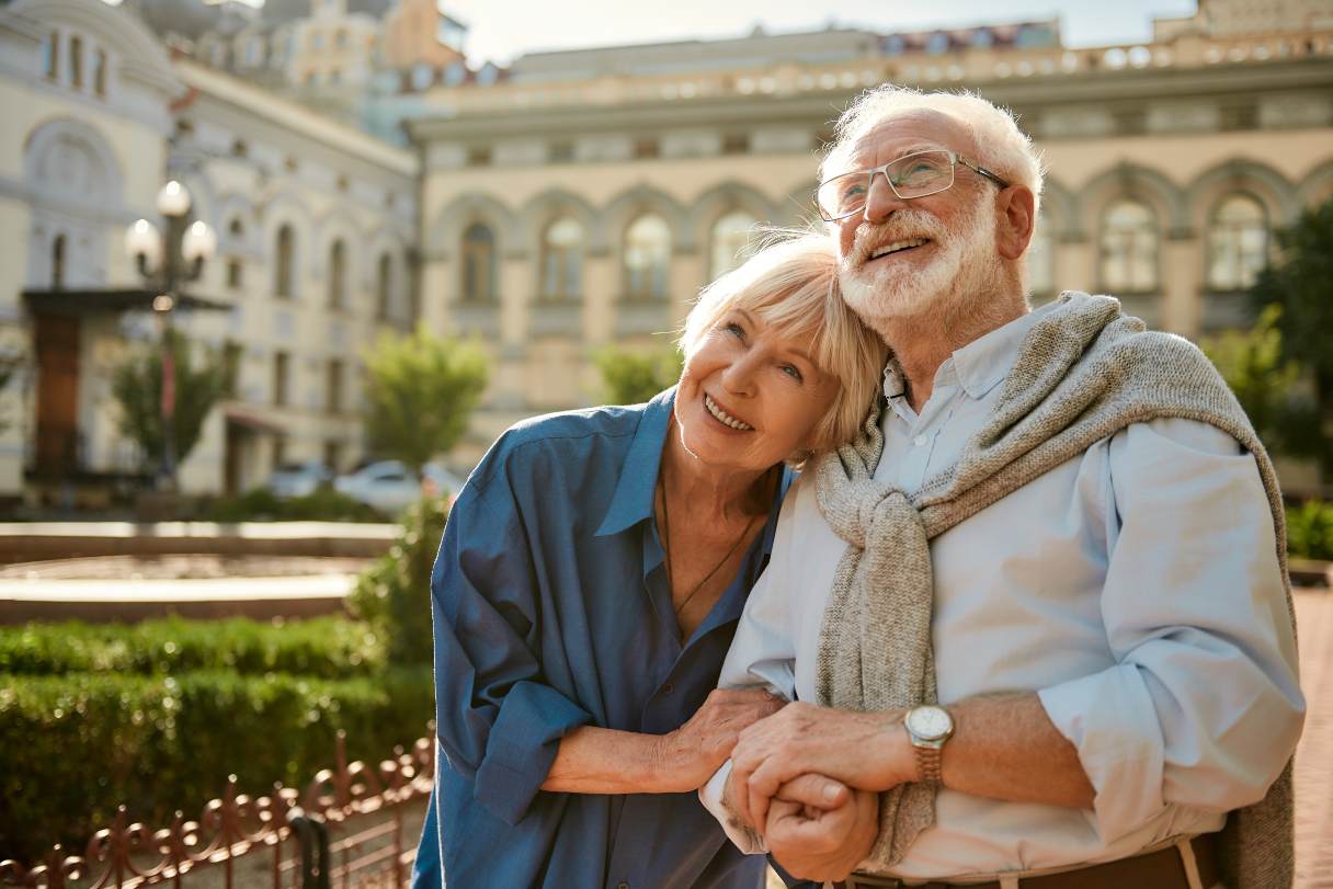 Senior man and woman walking together outside